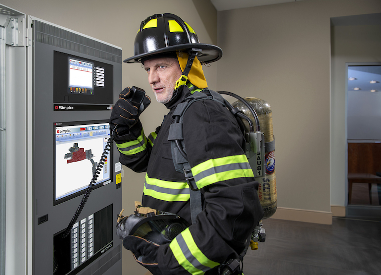Technician testing smoke detector and strobe appliance