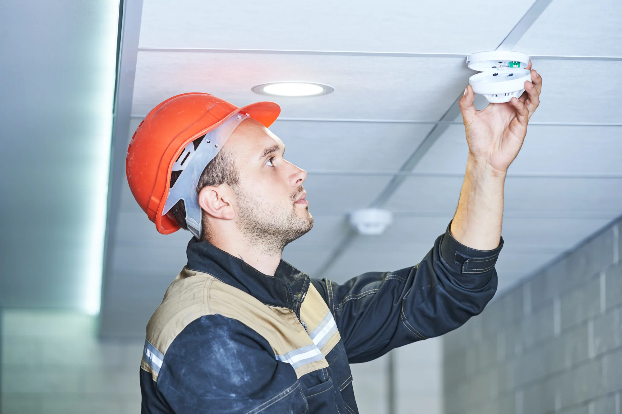 Gentleman working on fire alarm appliances